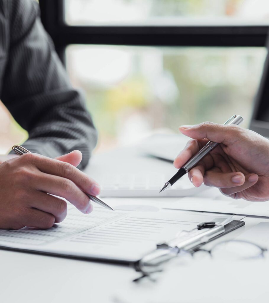 A man signing a paper. | Featured image for the Wills and Estates Lawyer Brisbane page.