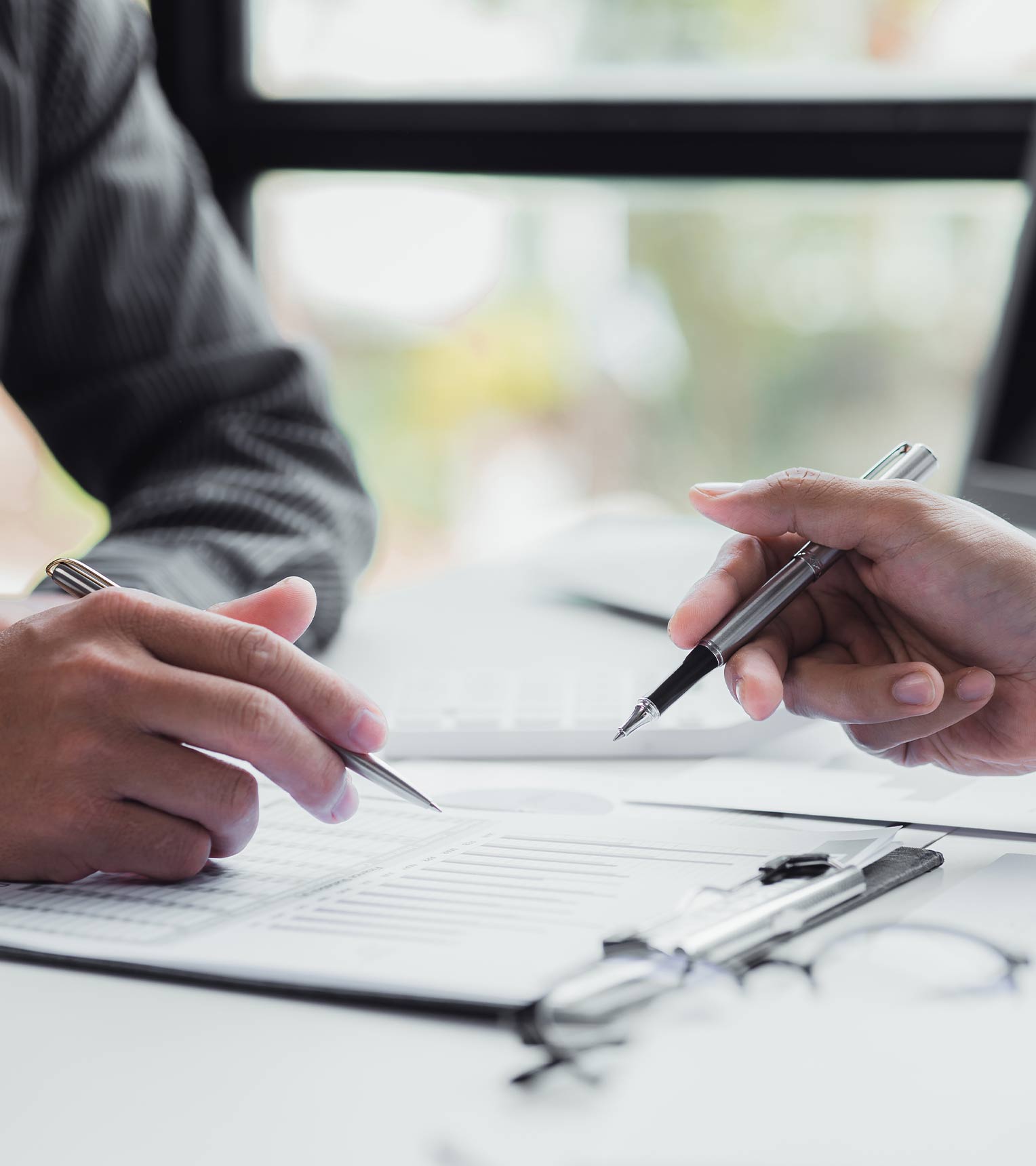 Two people reading over a document | Featured image for the Estate Administration Checklist blog.